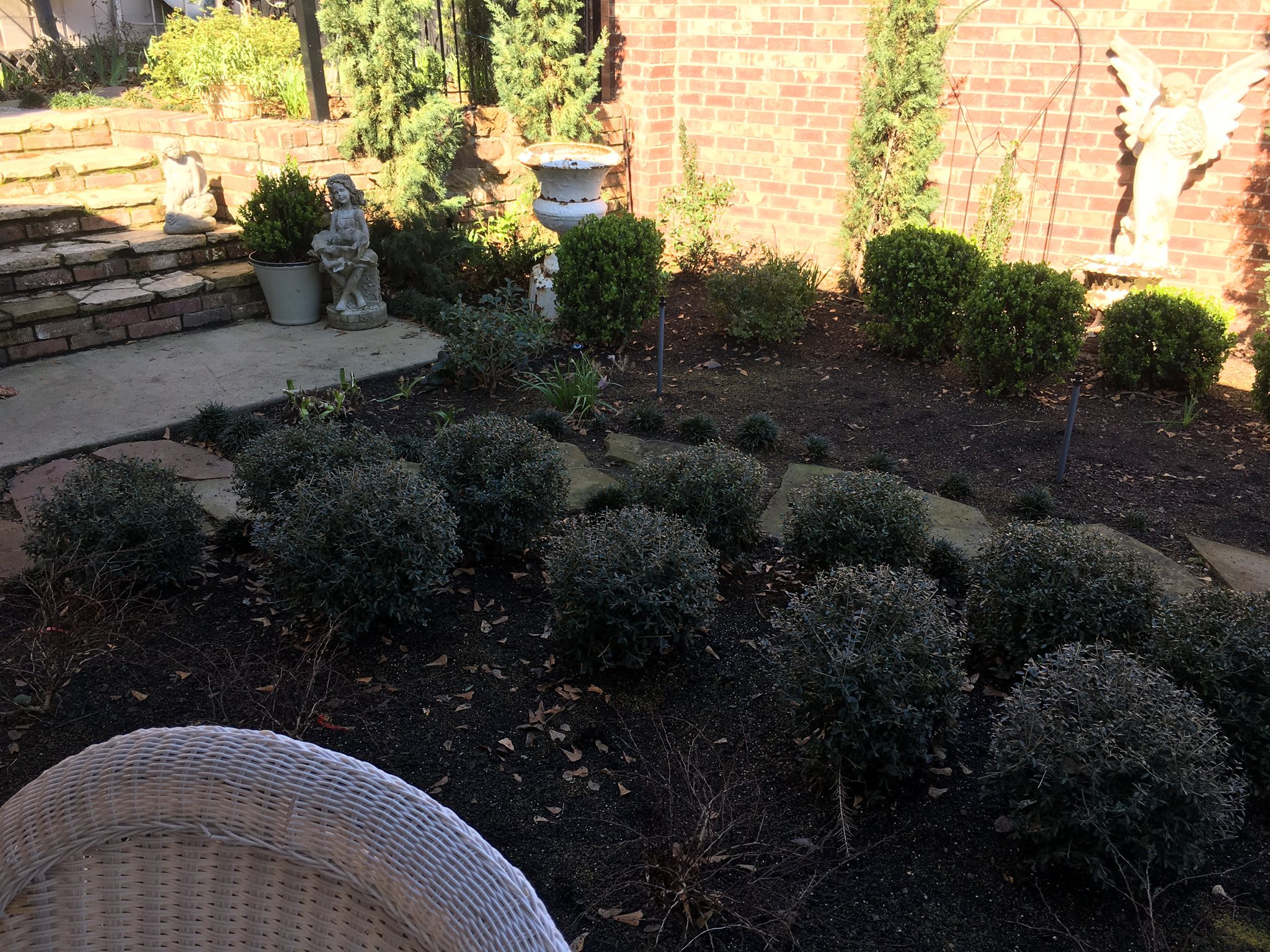 Residential landscape design with shrub trimming and garden beds in Center, TX by The Nature Gardeners